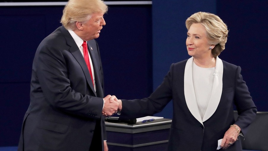 ST LOUIS, MO - OCTOBER 09:  Republican presidential nominee Donald Trump shakes hands with Democratic presidential nominee former Secretary of State Hillary Clinton during the town hall debate at Washington University on October 9, 2016 in St Louis, Missouri. This is the second of three presidential debates scheduled prior to the November 8th election.  (Photo by Chip Somodevilla/Getty Images) Getty Images North America  675358835 613703078